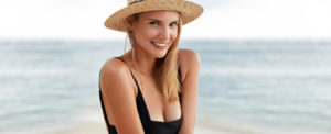 beautiful woman wearing sun hat on the beach
