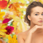 brunette woman with autumn background