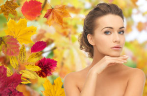 brunette woman with autumn background